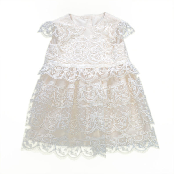 A christening dress with lace tiers - The Little Wedding Company