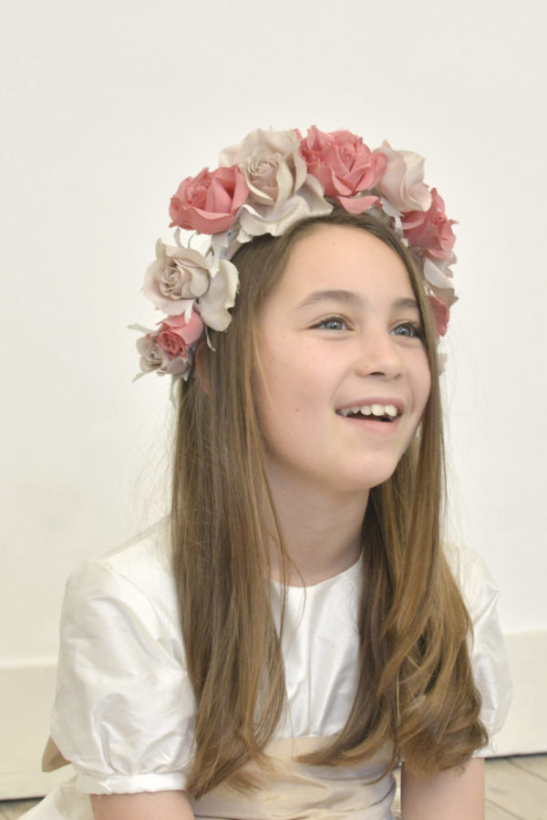 A girl wearing silk rose hairband and a bridesmaid dress - The Little Wedding Company