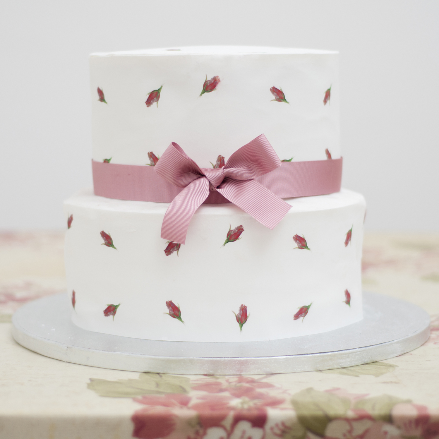 A printed rose pink two tier wedding cake - The Little Wedding Company