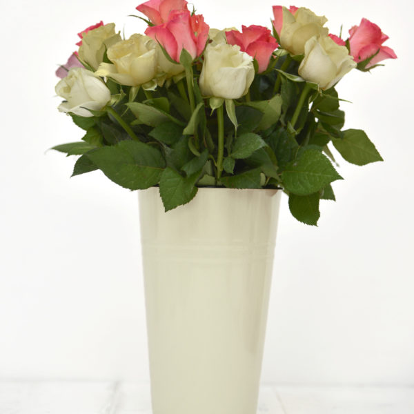 A cream metal vase with pink and white rose - The Little Wedding Company