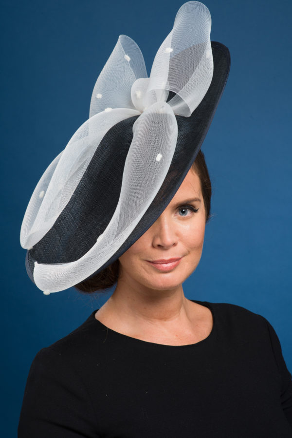 A woman wearing a navy blue hat with a white bow - The Little Wedding Company