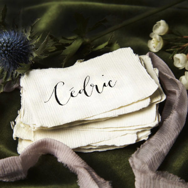 A group of handwritten calligraphy place names on handmade paper - The Little Wedding Company