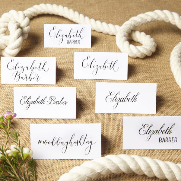 A group of folded handwritten calligraphy place names - The Little Wedding Company