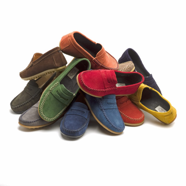 A pile of different coloured suede loafers - The Little Wedding Company